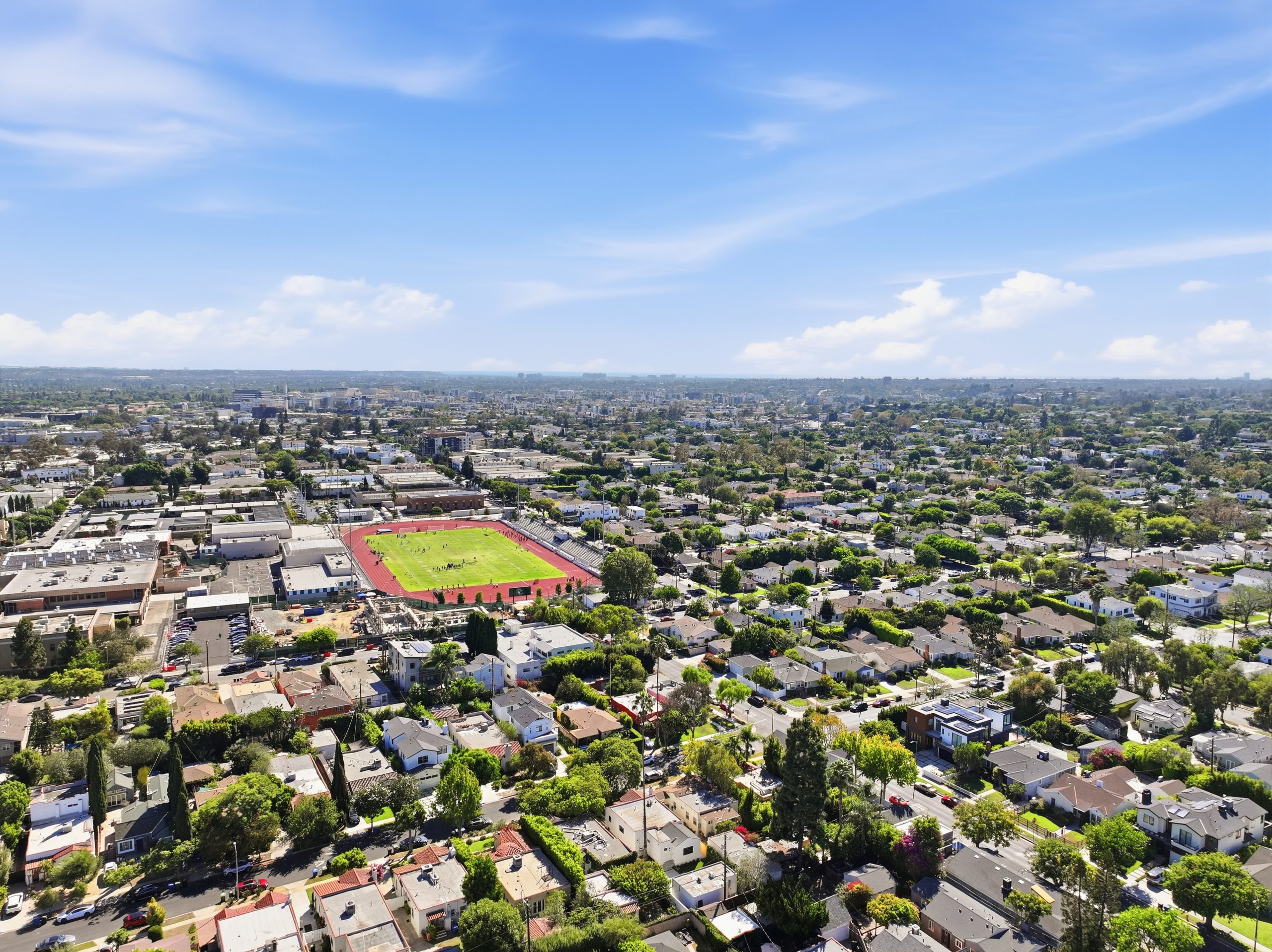 Aerial view over a Culver City residential neighborhood centered on a high school track and football field