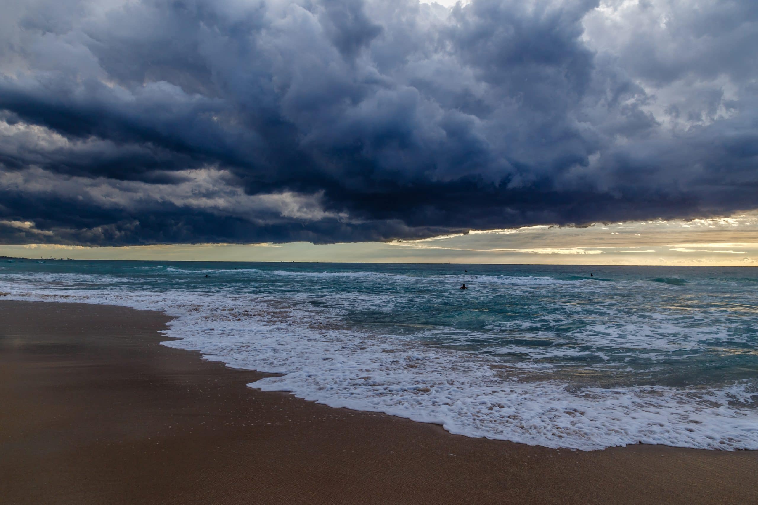 Dark storm clouds building over a beach and shoreline