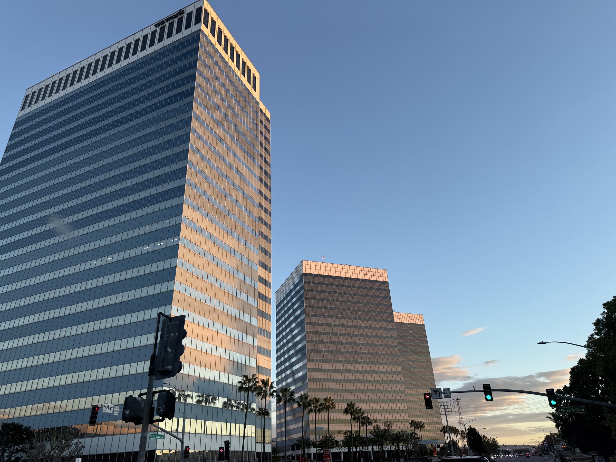 Glass office towers at the corner of Pacific Coast Highway and Grand Avenue in El Segundo at sunset