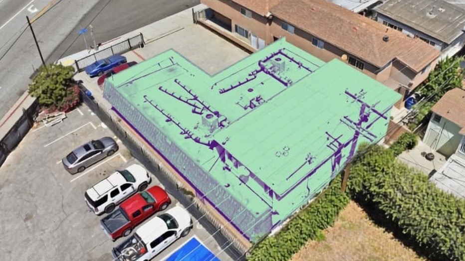 Aerial view of the mixed use building at 331 E. Carson Street in the Bixby Knolls area of Long Beach, with its parking lot, the two residential units behind it and Carson Street along the top