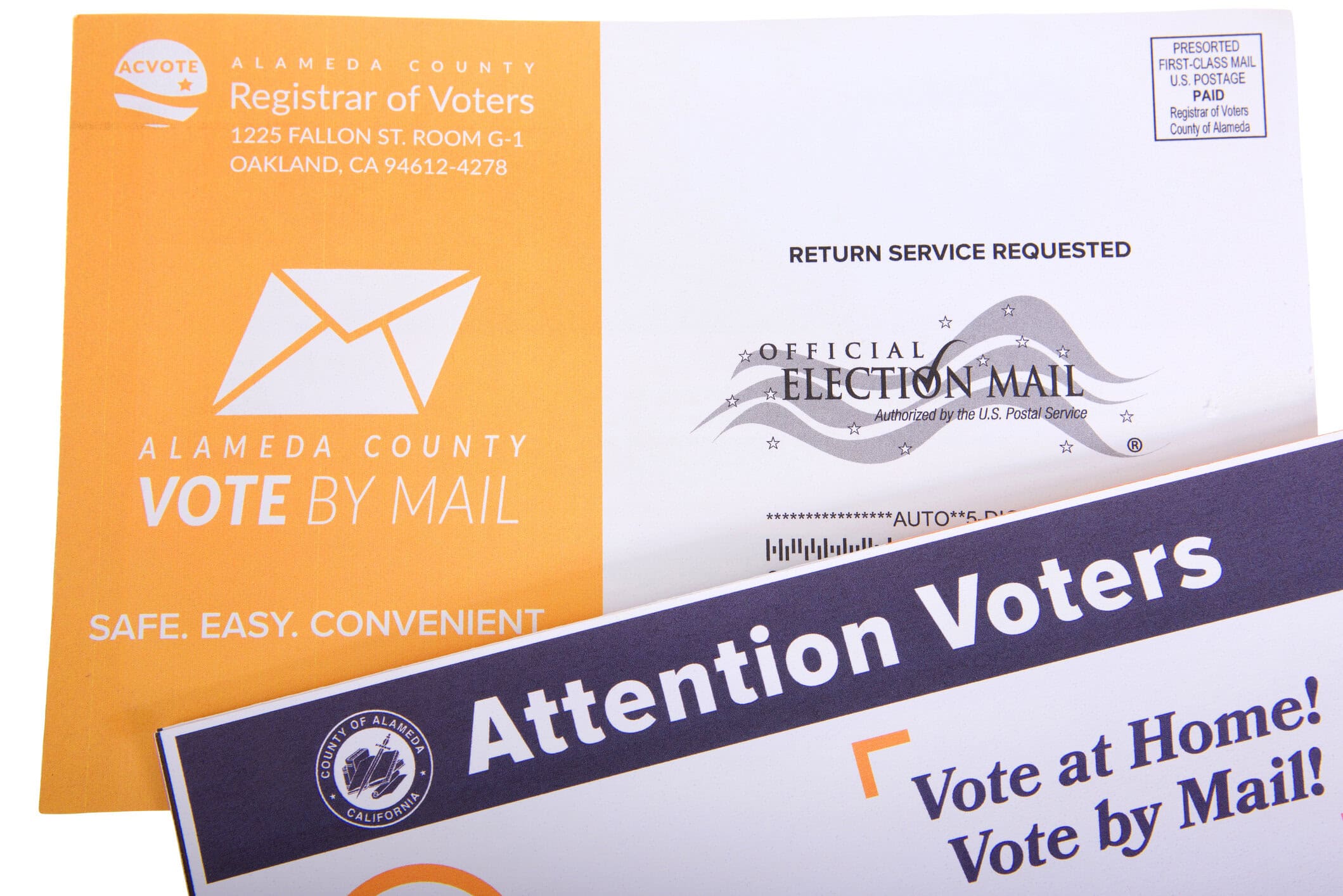 A California Vote By Mail envelope marked Official Election Mail, with a county mailer reading Attention Voters, Vote at Home, Vote by Mail, on a white background.